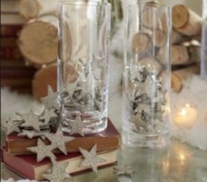 Decorate a fireplace mantel for Christmas with star tinsel