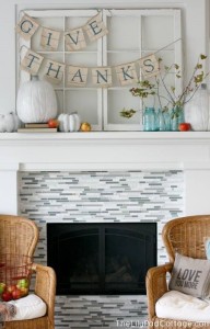 Mason jars and blue lettering on the Thanksgiving banner echo the blue tiles of the fireplace