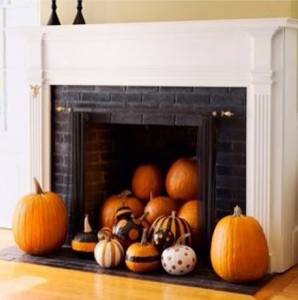 Pumpkins decorate an unused fireplace for Thanksgiving.