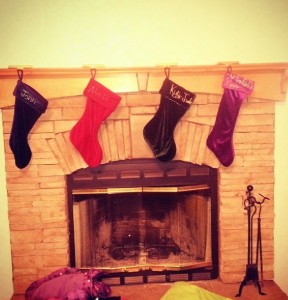 The stockings hanging from the mantel of this arched fireplace await Santa's treats.