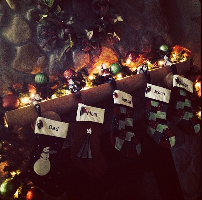 Patchwork and applique stockings hang from the mantel of an awesome fireplace.
