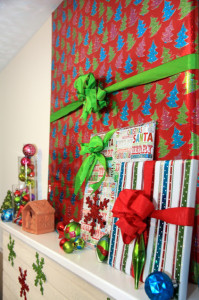 Hide TV for Christmas with gift wrap and bow.