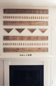 Scrap wood art display above fireplace