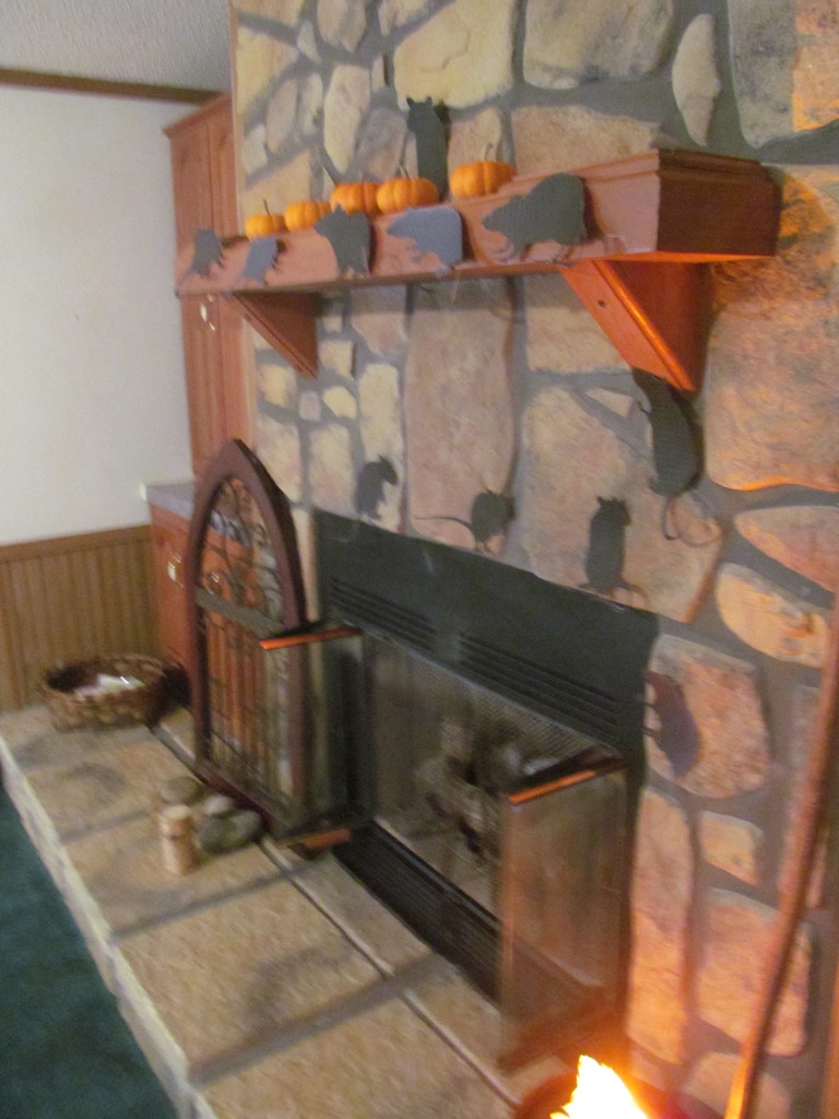 Add Halloween pumpkins, spider webs, witch's cauldron or witch's broom to the mantel and hearth.